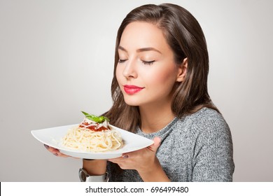 Beautiful Young Brunette Woman Eating Italian Pasta.