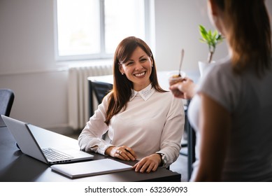 Beautiful Young Brunette Woman Having Refreshing Ice Cream In The Office. Great Team!