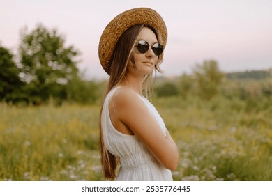 Beautiful young brunette woman with long hair and straw hat in park in summer. Head shot of gorgeous teenage girl in sunglasses. summer look, freedom field happiness portrait young woman - Powered by Shutterstock