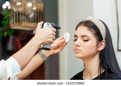 Beautiful Young Brunette Woman Receiving Airbrush Makeup By Makeup Artist.