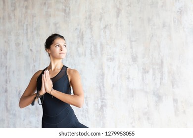 Beautiful Young Brunette Woman Yoga Instructor Doing Vrikshasana On A Mat In A Wooden Floor Standing In The Gym With Day Lighting