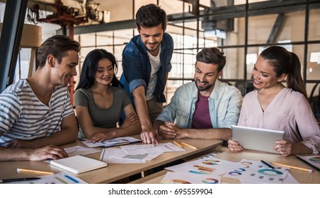 Beautiful Young Business People In Casual Clothes Are Discussing Work And Smiling At The Conference In Office