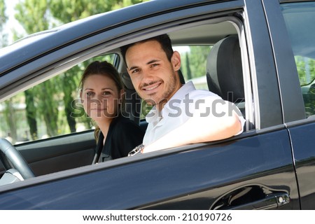 beautiful young business people man and woman driving a rental car for business trip