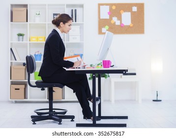 Beautiful Young Business Woman In Her Office Working On Computer,shallow Depth Of Field
