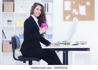 Beautiful Young Business Woman In Her Office Working On Computer,shallow Depth Of Field
