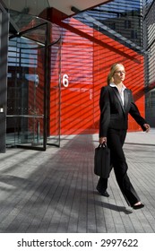 A Beautiful Young Business Woman Leaving Work At A Hi Tech Office Building