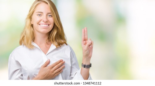Beautiful young business woman over isolated background Swearing with hand on chest and fingers, making a loyalty promise oath