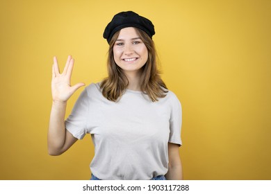 Beautiful Young Caucasian Girl Wearing French Look With Beret Over Isolated Yellow Background Doing Star Trek Freak Symbol