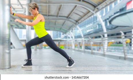 Beautiful young caucasian woman in fitness wear doing exercises at outdoor city. - Shutterstock ID 1414667204