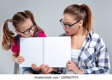 Beautiful Young Caucasian Woman A Little Girl In Glasses Holding The Book - Empty Cover For Mock Up Template