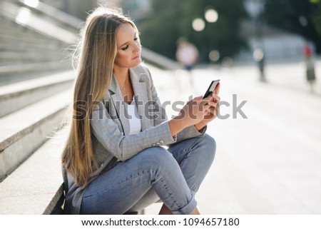 Similar – Image, Stock Photo Blonde woman looking at her smartphone outdoors