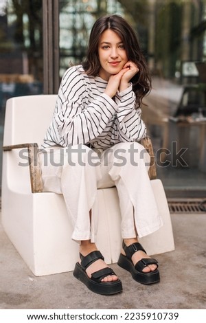 Similar – Woman in work wear in her workshop by table with handmade items