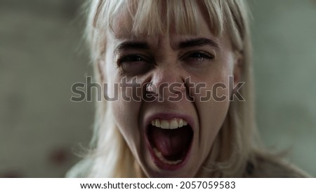 Beautiful Young Caucasian Woman Screaming Out of Anger Straight in the Camera. Girl in Agony Releasing Her Emotions While in Tears. Blonde Sad Girl with Anxiety.