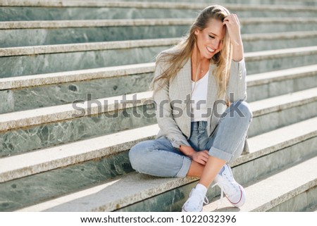 Similar – Blonde young caucasian woman smiling on steps