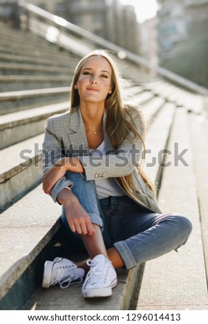 Similar – Blonde young caucasian woman smiling on steps