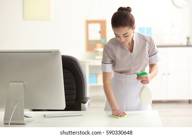 Beautiful Young Charwoman Wiping Dust In Office