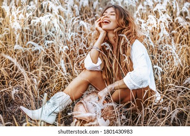 Beautiful Young Cheerful Woman Wearing Cowgirl Boots On The Field