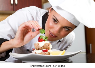 beautiful young chef decorating delicious dessert
