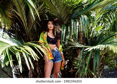 Beautiful young colombian woman with afro hairstyle wearing fashionable casual clothes, posing outdoor, looking at camera.