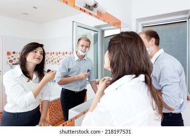 Beautiful Young Couple In The Bathroom Getting Ready For Work