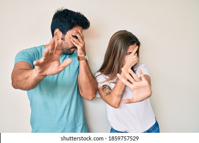 Beautiful young couple of boyfriend and girlfriend together covering eyes with hands and doing stop gesture with sad and fear expression. embarrassed and negative concept.  - Shutterstock ID 1859757529