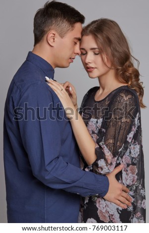 Beautiful young couple in a classic shirt and dress