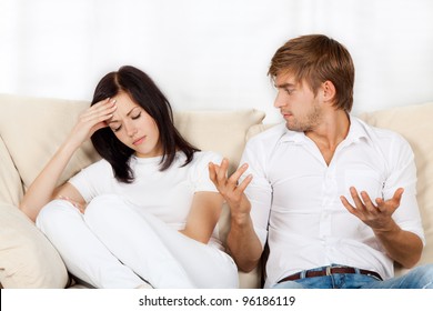 Beautiful Young Couple Conflict Sitting On A Couch Argue Unhappy, Portrait Young Man And Woman