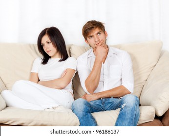 Beautiful Young Couple Conflict Sitting On A Couch Argue Unhappy, Portrait Young Man And Woman