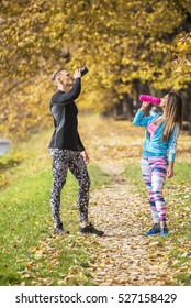 Beautiful Young Couple Cooling Down After Running In The Park. Autumn Environment.