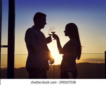 Beautiful Young Couple Drinking Wine On A Terrace Of A Bar