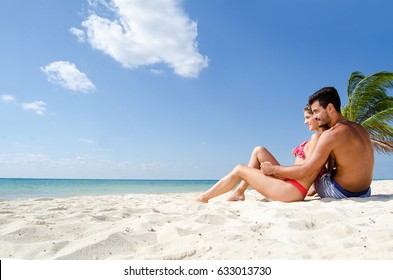 Beautiful young couple enjoying the beach
