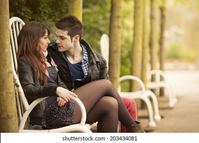 Beautiful Young Couple Flirting On Bench