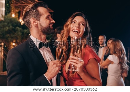 Similar – Image, Stock Photo A fashionable couple, dressed in white and wearing avant-garde shoes, is having some fun in the green meadow. With a cow. It’s a great outdoor wanderlust at its best. On a wild summer night.