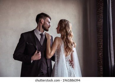 Beautiful Young Couple. Groom And Bride. A Modern Wedding. Dark Interior.