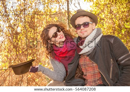 beautiful young couple having fun in the park at sunset
