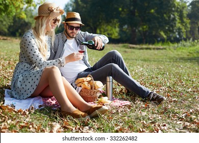 Beautiful Young Couple Having Picnic in Countryside. Happy Family - Powered by Shutterstock