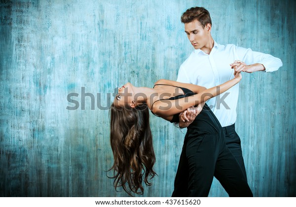 Beautiful young couple in love\
dancing tango with passion. Professional dancers. Latino\
dancers.