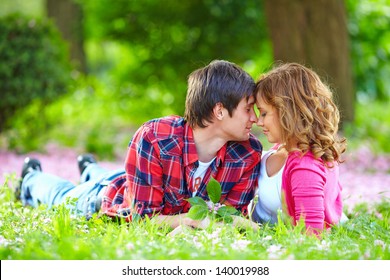 Beautiful Young Couple In Love Lying In Spring Grass