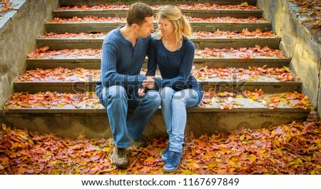 a beautiful young couple in love on nature in autumn park