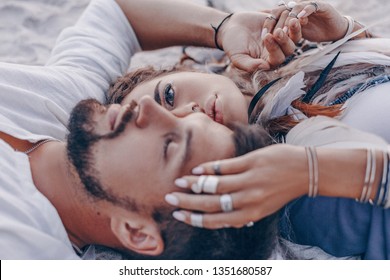 beautiful young couple lying on sand on the beach. love and relationships concept