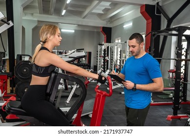 Beautiful Young Couple Of Man And Woman Are Training In The Gym To Keep Fit. The Concept Of A Healthy Lifestyle