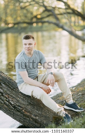 Similar – Image, Stock Photo Stylish teenager sitting on a wooden bench