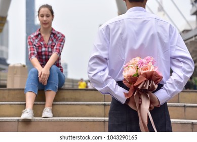 Beautiful Young Couple Sitting  Man Send A Bouquet Of Flowers To A Woman Focus Flower Bouquet.