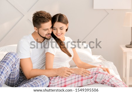 Similar – Image, Stock Photo Man and pregnant woman looking baby clothes