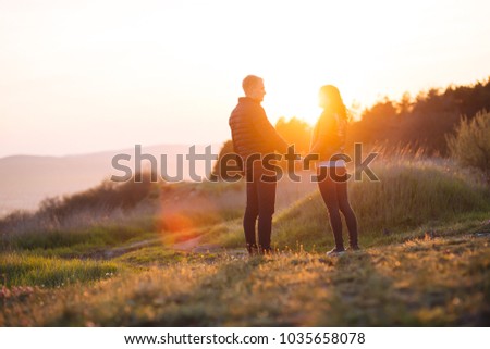 Similar – Schwestern sitzen auf einer Wiese im Sonnenuntergang