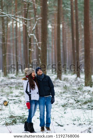 Beautiful Young Couple Walking in Snowy Winter Forest Embrace Happy Valentines Day Outdoor