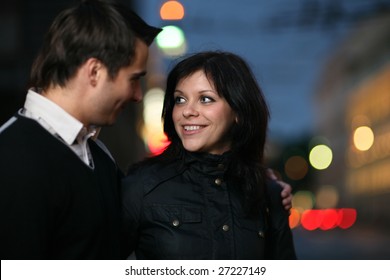 Beautiful Young Couple Walking Together In Night City. Shallow DOF.