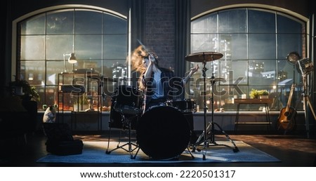 Beautiful Young Drummer Playing at a Band Rehearsal, Doing Tricks with Drumsticks. Learning Drum Solo on Drums and Cymbals in Evening Living Room Loft Apartment.