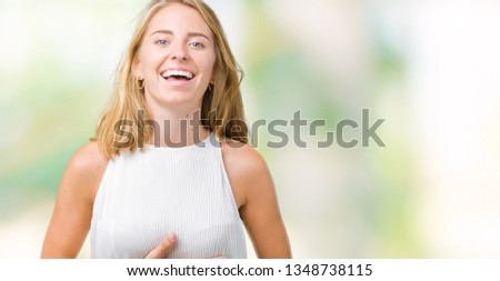 Beautiful young elegant woman over isolated background Smiling and laughing hard out loud because funny crazy joke. Happy expression.