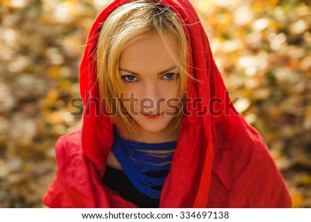 Beautiful young elegant woman wearing ivory shawl on autumn day